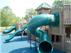 Various Slides Coming off the Side of of Playground Structure